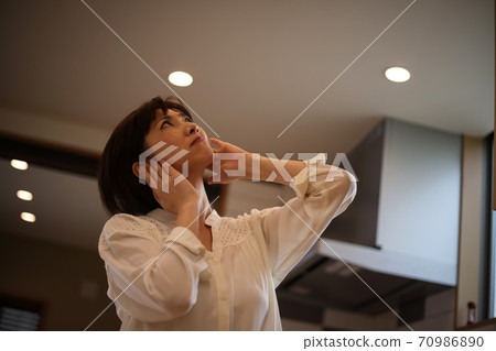 Woman suffering from noise on the upper floor Woman suffering from noise on the upper floor 70986890