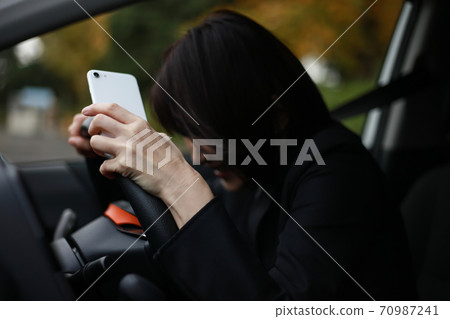 Woman stepping on a sudden brake Woman stepping on a sudden brake 70987241