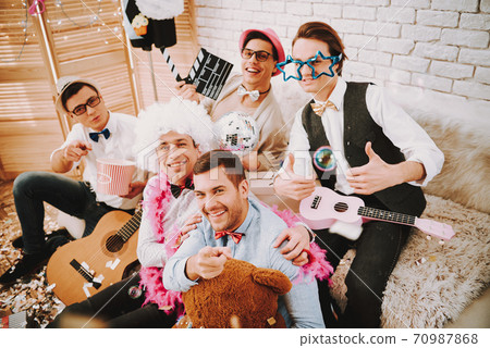 Gay man with guitar shows super gesture.  70987868