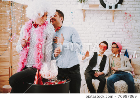 A man in a shirt compliments a man with a scarf.  70987869