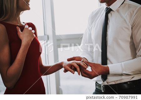 Man is proposing to woman with engagement ring. Man is proposing to woman with engagement ring. 70987991