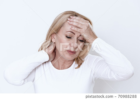 Girl with a virus holds onto her head.  70988288