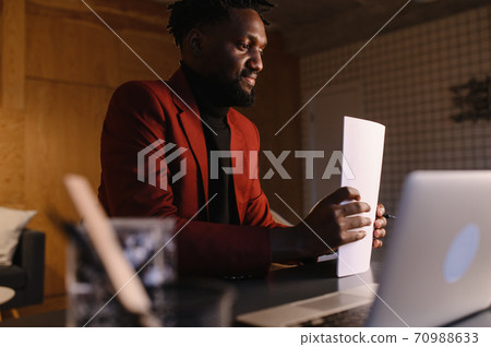 black business man working on laptop and taking notes 70988633