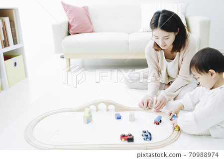 Parent and child playing with toys Parent and child playing with toys 70988974