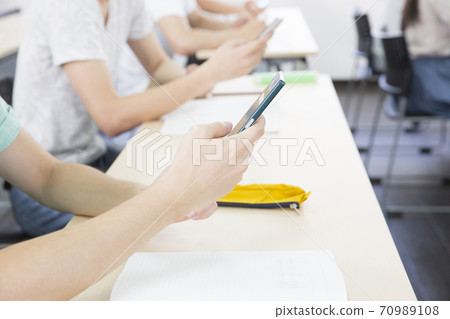 Youth operating a smartphone 70989108