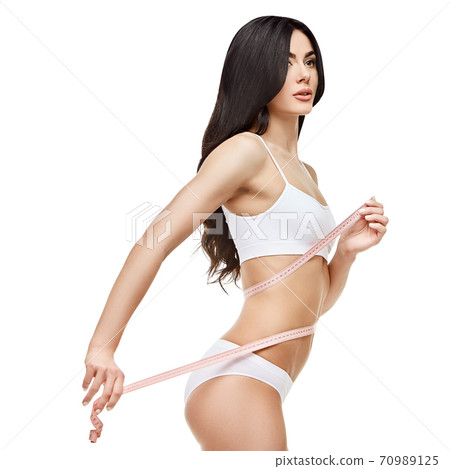 Slim tanned woman's body isolated on white background - waist measurement 70989125