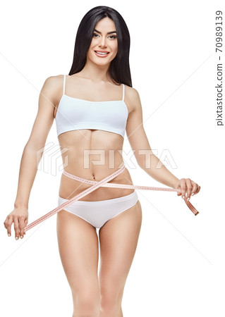 Slim tanned woman's body isolated on white background - waist measurement 70989139