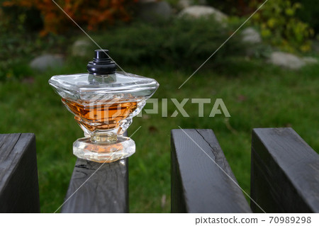 Perfume bottle on the bench Perfume bottle on the bench 70989298