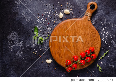 Herbs and condiments on black stone background. 70990973