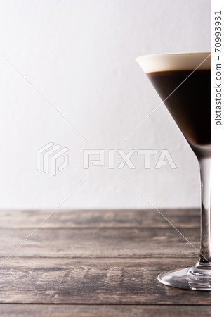 Martini espresso cocktail in glass on wooden table.Copy space Martini espresso cocktail in glass on wooden table.Copy space 70993931