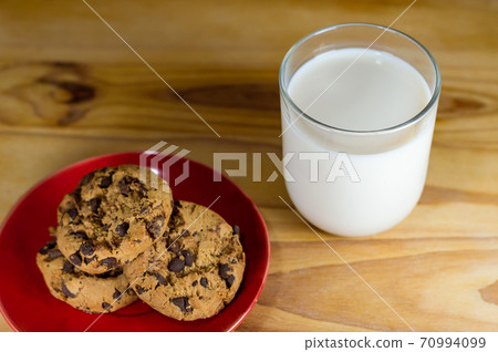 Chocolate Chip Cookies on red plate and Milk Chocolate Chip Cookies on red plate and Milk 70994099
