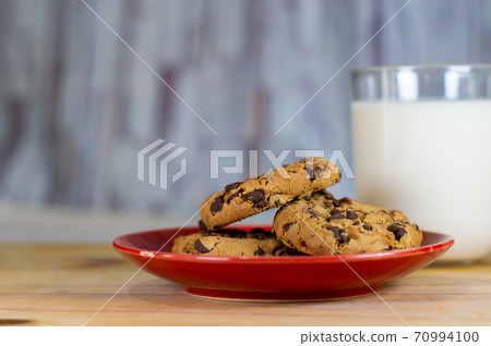 Chocolate Chip Cookies on red plate and Milk 70994100