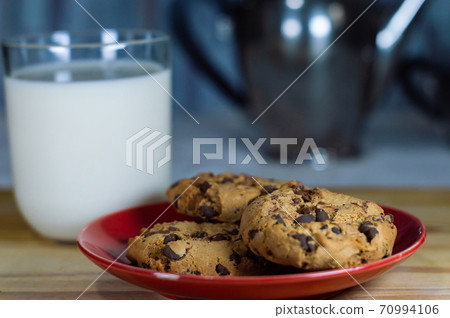 Chocolate Chip Cookies on red plate and Milk Chocolate Chip Cookies on red plate and Milk 70994106