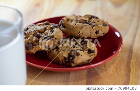 Chocolate Chip Cookies on red plate and Milk Chocolate Chip Cookies on red plate and Milk 70994108