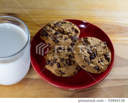 Chocolate Chip Cookies on red plate and Milk Chocolate Chip Cookies on red plate and Milk 70994136