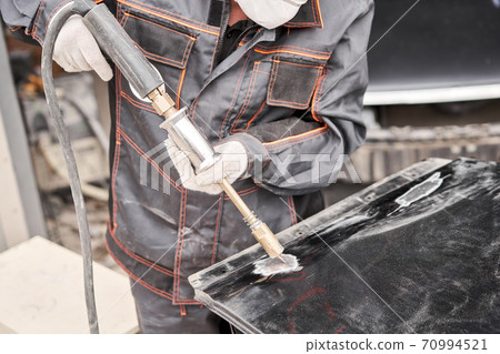 Spotter, a Welding machine for straightening dents on the car body. spot welding of metal. Repair service worker fix damaged car. 70994521