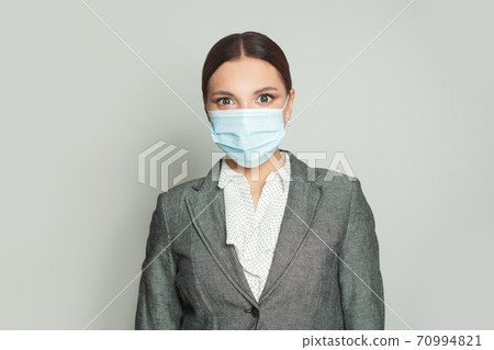Confident woman in protective medical mask on white background Confident woman in protective medical mask on white background 70994821