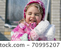 Close up Portrait of cute little girl having fun in the snow 70995207