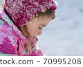 Close up Portrait of cute little girl in winter 70995208