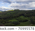Aerial view over agricultural fields and road. Dark clouds in the sky 70995578