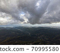 Aerial view over agricultural fields and road. Dark clouds in the sky 70995580