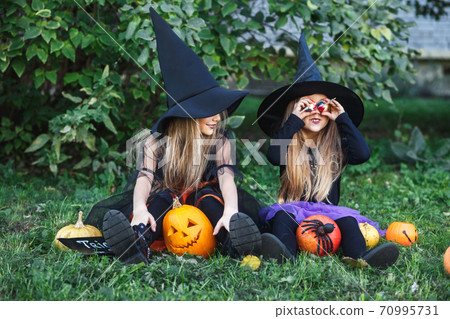 Happy Halloween. Children in suits and with pumpkins having fun outdoor Happy Halloween. Children in suits and with pumpkins having fun outdoor 70995731