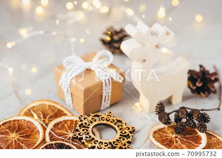 The figure of the reindeer, gift box, dry oranges and pine cone. The figure of the reindeer, gift box, dry oranges and pine cone. 70995732