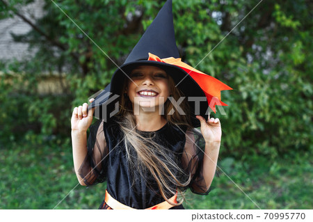 Little girl in witch costume outdoor. Happy Halloween Little girl in witch costume outdoor. Happy Halloween 70995770