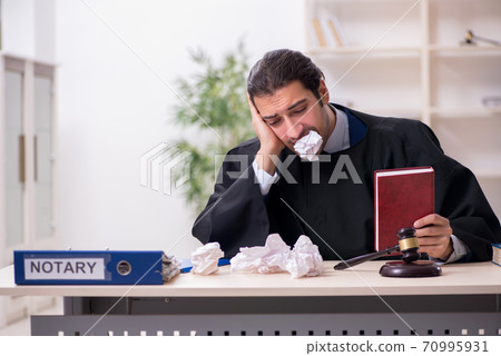 Young male judge working in courthouse 70995931