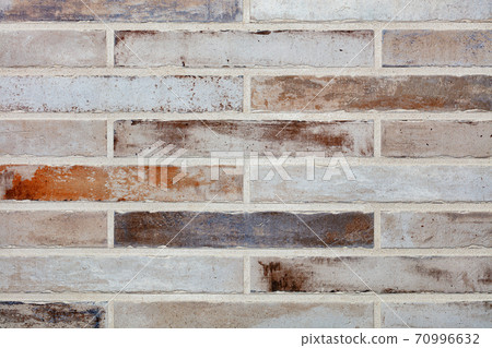 Texture of a stone wall made of old long bricks. 70996632