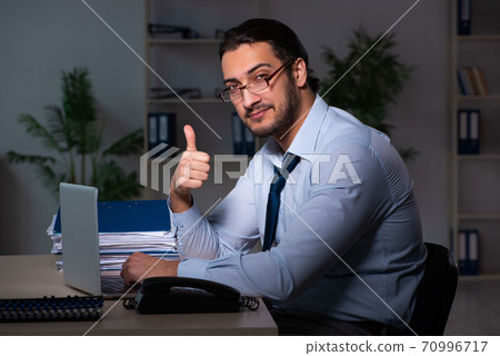 Young businessman working late in the office 70996717