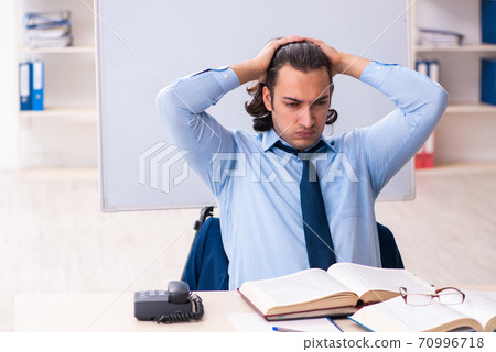Young businessman student studying at workplace 70996718
