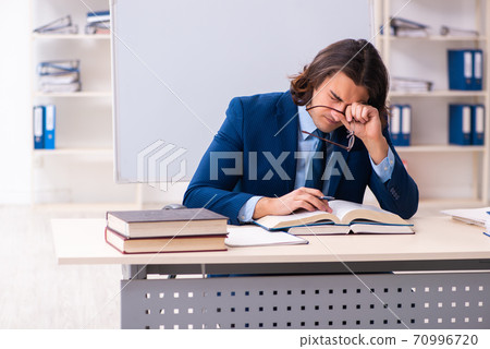 Young businessman student studying at workplace 70996720