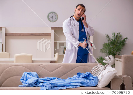 Young male paramedic visiting skeleton patient Young male paramedic visiting skeleton patient 70996750