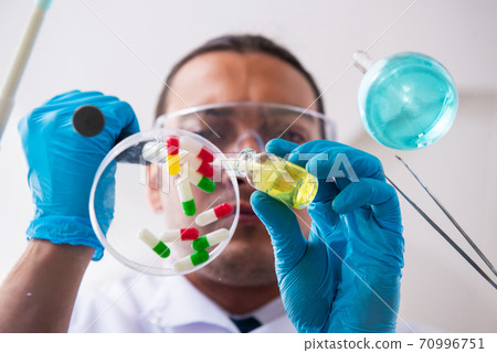 Young male pharmacist working in the lab Young male pharmacist working in the lab 70996751