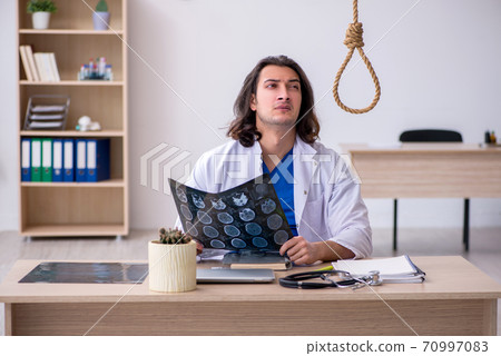 Young male doctor committing suicide in the hospital 70997083