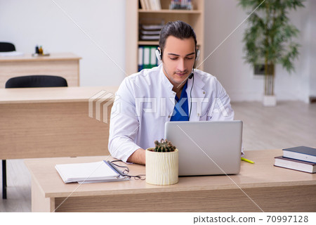 Young male doctor in telemedicine concept Young male doctor in telemedicine concept 70997128