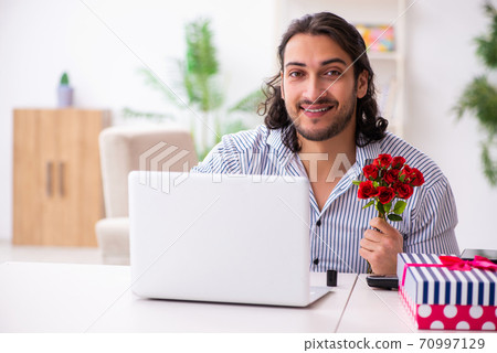 Young man in christmas concept at home 70997129
