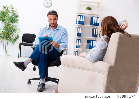 Pregnant woman visiting young male psychologist Pregnant woman visiting young male psychologist 70997174