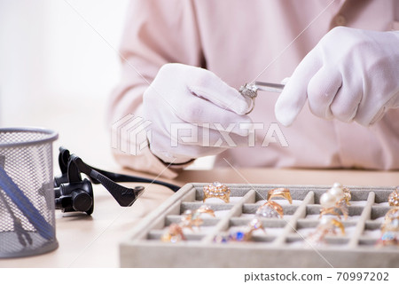 Old male jeweler at workshop Old male jeweler at workshop 70997202