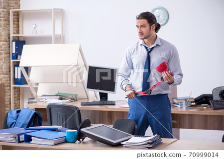 Young male employee unhappy with excessive work Young male employee unhappy with excessive work 70999014