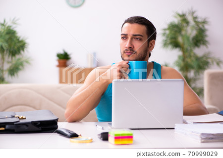Young man working from house during pandemic Young man working from house during pandemic 70999029