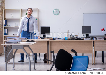 Young male employee unhappy with excessive work Young male employee unhappy with excessive work 70999031