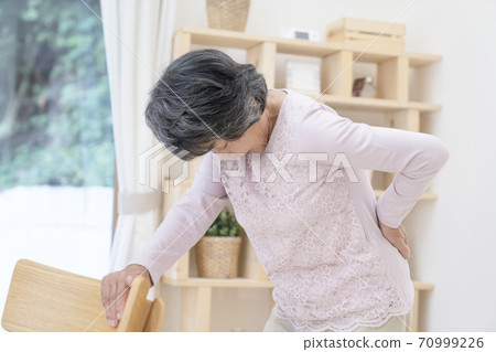 Senior woman with low back pain 70999226