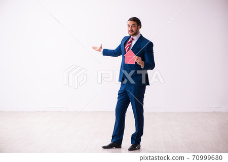 Handsome male realtor working indoors 70999680