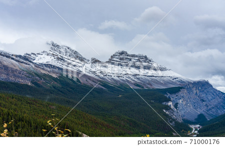 Snow-capped Cirrus Mountain in late autumn season. Seen from the Icefields Parkway (Alberta Highway 93), Jasper National Park, Canada. Snow-capped Cirrus Mountain in late autumn season. Seen from the Icefields Parkway (Alberta Highway 93), Jasper National Park, Canada. 71000176