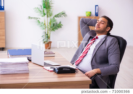 Young male employee working in the office 71000366