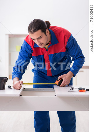 Young male carpenter working indoors Young male carpenter working indoors 71000452