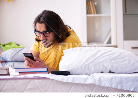 Young male student preparing for exams at home 71000905
