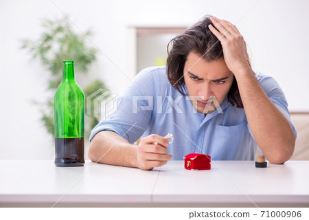 Young male alcoholic in unrequited love concept Young male alcoholic in unrequited love concept 71000906